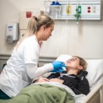 Nursing student talks with a patient